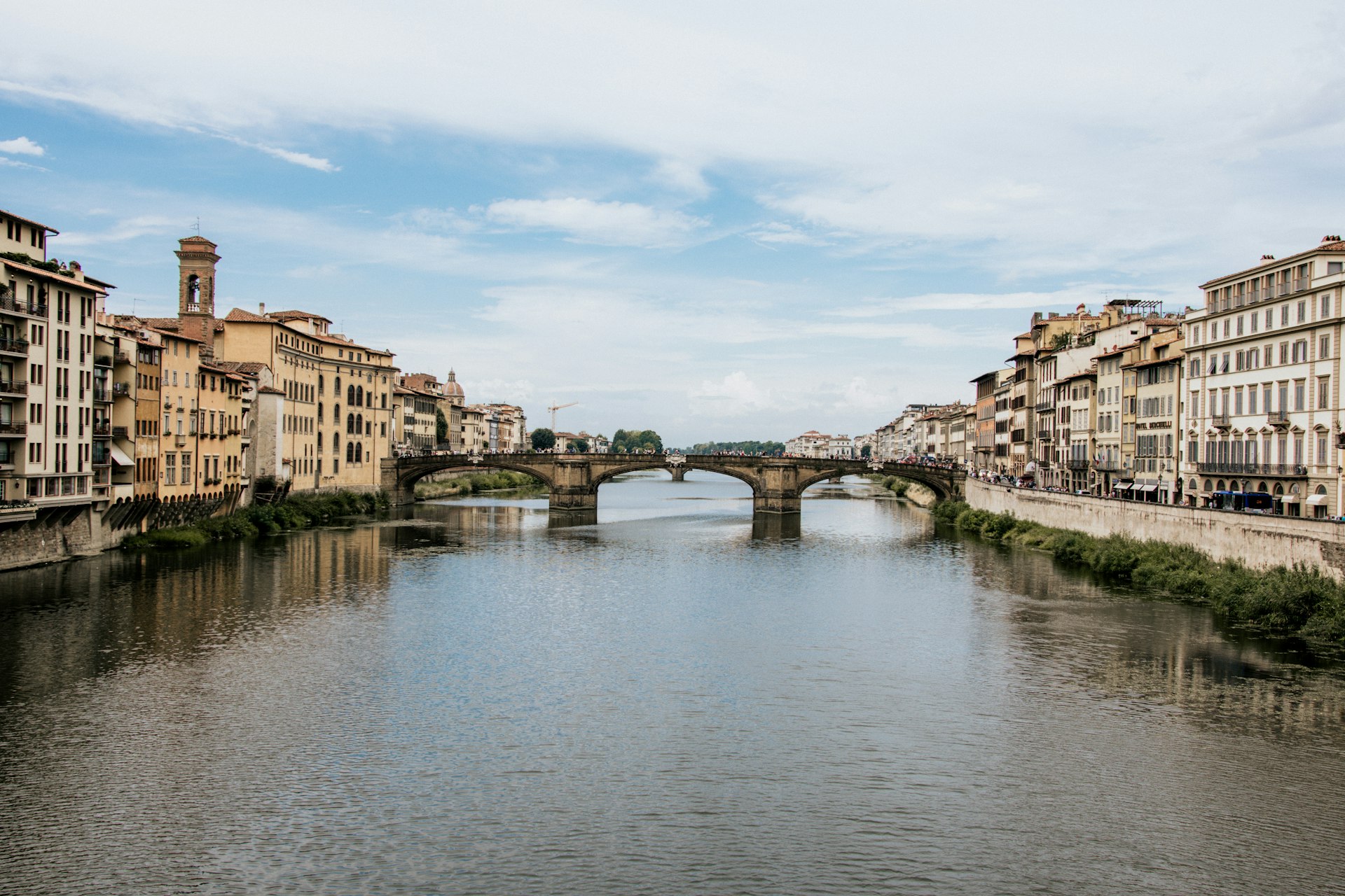 river between concrete buildings under blue sky during daytime